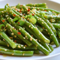 - 1 pound fresh green beans, trimmed - 4 cloves garlic, minced - 2 tablespoons sesame oil - 1 tablespoon soy sauce - 1 tablespoon toasted sesame seeds - 1 teaspoon red pepper flakes - 1 tablespoon olive oil - 1 green onion, thinly sliced - Salt Fresh green beans bring a crisp and bright flavor. Garlic adds depth and aroma. Sesame oil gives a nutty taste that enhances the dish. Soy sauce adds saltiness and umami. Toasted sesame seeds finish with a delightful crunch. You can spice things up with red pepper flakes. Olive oil gives a nice base for saut&eacute;ing the beans. The green onion adds fresh color and a mild bite. Salt rounds out all the flavors, ensuring each bite is satisfying. Using these ingredients makes the dish easy and fun. You can play with flavors and adjust to your taste. This dish offers a delightful mix of crunch and flavor. Enjoy the process of making this simple yet delicious side! {{ingredient_image_2}} - First, bring a large pot of water to a boil. - Add a generous pinch of salt. - Carefully add 1 pound of trimmed green beans. - Blanch the beans for about 3 minutes. - They should turn bright green and be just tender. - Drain the beans and plunge them into ice water. - This stops the cooking and keeps their color. - After chilling, drain them again and set aside. - In a small bowl, combine 4 cloves of minced garlic. - Add 2 tablespoons of sesame oil and 1 tablespoon of soy sauce. - If you like spice, add 1 teaspoon of red pepper flakes. - Stir the mixture well to blend the flavors. - Set the bowl aside for later use. - Heat 1 tablespoon of olive oil in a large skillet. - Use medium-high heat until the oil shimmers. - Add the blanched green beans to the skillet. - Saut&eacute; for 3 to 4 minutes, stirring as you go. - Aim for a slight caramelization while they stay crisp-tender. - Pour the prepared garlic and sesame sauce over the beans. - Stir everything well and cook for an additional 2 minutes. - Sprinkle 1 tablespoon of toasted sesame seeds on top. - Gently toss to coat the beans evenly. - Taste and adjust the salt as needed. - Transfer the green beans to a serving dish. - Garnish with thinly sliced green onions for freshness. To get green beans just right, avoid overcooking. Overcooked beans turn mushy and lose flavor. Blanch them for only three minutes. This keeps them bright and crunchy. After blanching, cool them in ice water. This halts cooking. It also helps keep their vibrant color. For crisp-tender green beans, saut&eacute; them for three to four minutes. You want them to caramelize slightly. Stir occasionally to ensure even cooking. This method makes them tasty and adds a nice texture. You can use other oils for different tastes. Try avocado oil for a buttery flavor. It works well with the garlic too. You can also mix in some citrus zest for brightness. Lemon or lime zest adds a fresh twist. Customizing seasonings is fun. Add more red pepper flakes for heat. If you want a sweeter taste, mix in a touch of honey. Adjust the soy sauce to your liking. This way, you can make the dish your own. For a stunning presentation, serve the beans in a bright bowl. The green color pops against white dishes. Sprinkle extra sesame seeds on top for crunch and flair. You can also add a few slices of lime. This adds a nice touch of color. Use a shallow dish to showcase the beans. It allows for a beautiful display. Garnish with green onions just before serving. This adds freshness and makes the dish even more appealing. Pro Tips Blanching Technique: To ensure the green beans maintain their vibrant color and crisp texture, be sure to plunge them into ice water immediately after blanching. This process, known as shocking, halts the cooking and locks in their bright green hue. Adjusting Spice Level: If you prefer a milder flavor, start with half the amount of red pepper flakes and adjust according to your taste. Remember, you can always add more spice, but it&rsquo;s hard to take it out once it&rsquo;s in! Even Cooking: When saut&eacute;ing the green beans, ensure they are spread out evenly in the skillet. Overcrowding can lead to steaming rather than saut&eacute;ing, preventing that delightful crispy texture. Serving Suggestions: For a complete meal, serve these green beans alongside grilled chicken or tofu. They also make a great addition to a grain bowl or as a side dish for any Asian-inspired meal. {{image_4}} You can enhance your sesame garlic green beans by adding proteins. Chicken or shrimp make great choices. Just cook them in the skillet first, then add the green beans. For a vegetarian option, try using tofu. Cube the tofu and saut&eacute; it until golden. Then, mix it with the green beans. This adds protein and makes your meal more filling. You can easily change the flavor profile of this dish. Experiment with different sauces like teriyaki or hoisin. These sauces bring unique tastes that pair well with green beans. You can also add nuts for extra crunch. Toasted almonds or cashews work well. They add texture and a nutty flavor that balances the garlic and sesame. Adjusting the spice level is simple. If you like heat, add more red pepper flakes. You can also include fresh chili peppers for a different kick. Another option is to use sriracha or chili garlic sauce. These will spice up your dish and give it a bold flavor. Just remember to start small and taste as you go to find your perfect heat. To keep your sesame garlic green beans fresh, store them in the fridge. Use airtight containers to prevent moisture loss and flavor fading. If you have extra sauce, store it separately to keep the beans crisp. Aim to eat leftovers within three days for the best taste. When reheating, avoid the microwave. It can make the beans soggy. Instead, use a skillet over medium heat. Add a splash of water or oil to help steam them lightly. Heat for about five minutes, stirring gently until warm. This method helps keep the beans crunchy. You can freeze sesame garlic green beans. First, blanch them briefly in boiling water. Then, cool them in ice water and drain. Place the beans in freezer bags, remove air, and seal tightly. To thaw, leave them in the fridge overnight or use the microwave on low. Fresh green beans last about 5 to 7 days in the fridge. Keep them in a plastic bag or container. Check for signs of spoilage, like soft spots or a slimy texture. If they look dull or wilted, it is best to throw them out. Yes, you can use frozen green beans! They are convenient and save time. You should adjust the cooking time. Saut&eacute; them around 5 to 7 minutes longer than fresh green beans. They may have a softer texture, but they will still taste great. Sesame garlic green beans match well with many dishes. They pair nicely with rice, grilled chicken, or fish. Consider serving them alongside stir-fried tofu for a vegetarian option. These beans also work well with Asian-inspired meals, like teriyaki or sesame chicken. In summary, making Sesame Garlic Green Beans is simple and fun. You start with fresh green beans and a flavorful sauce. Cooking them just right gives you a great texture. Add some protein or spice to make it your own. Remember to store leftovers properly and enjoy them later. Aim for balance in flavor and presentation. This dish fits well with many meals. Try it out and see how tasty green beans can be.